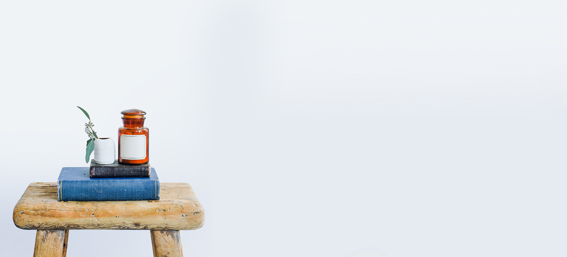 A person sitting on top of a wooden bench.