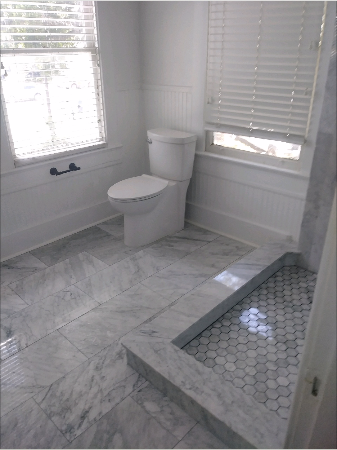 Same custom tile bathroom, glass-enclosed shower view